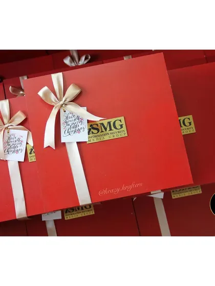 Corporate Christmas gifting done right. These elegant red boxes with custom logos were prepared for a client's holiday gifting.