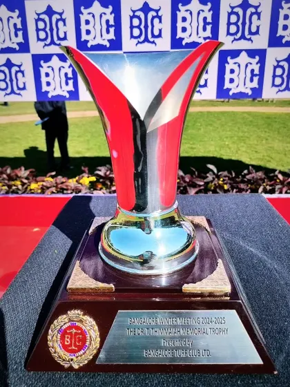 The Dr. T. Thimmaiah Memorial Trophy, a beautiful silver cup with a unique flared design.