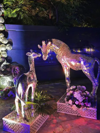 Adding to the glittering menagerie, these mirror-work giraffe statues bring a touch of whimsical glamour to the Sangeet decor.