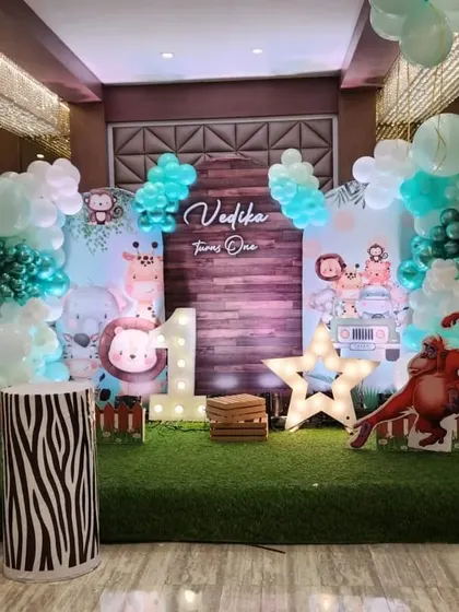 This cute safari theme for Vedika's first birthday uses softer pastel colors and adorable cartoon animal cutouts, creating a friendly and welcoming jungle for the little ones.