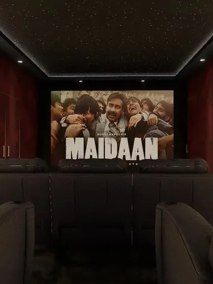 A cozy theater with dark recliners and a starry ceiling, perfect for watching the latest blockbuster.