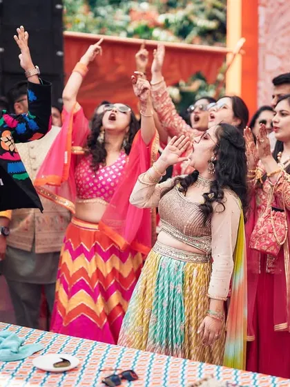 Look at that energy! This is the result of a 'Bride Side vs Groom Side' cheer-off. My job is to get every guest personally invested and shouting their support, creating memories you'll talk about for years.