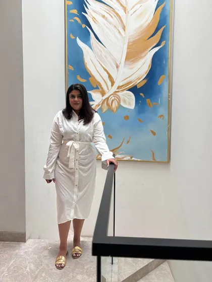 Aishwarya standing on the staircase of a completed project. We built it, designed it, and stressed over it, and now we are admiring it like a proud parent.