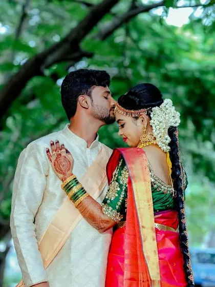 A tender kiss on the forehead. This classic, candid gesture is a beautiful expression of love and affection between the couple.