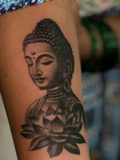 A detailed look at the serene expression on this Buddha portrait tattoo. Getting the facial features right is the most important part of our process.