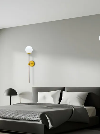 A pair of globe sconces in a minimalist bedroom, adding a touch of style and warmth.