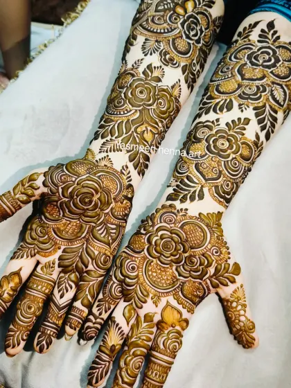 This angle shows the beautiful flow of the floral patterns from the palm up the arm in this bridal design.
