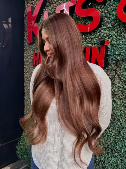 A soft, candid shot of our brunette bride enjoying her new hair. The color looks so natural and beautiful.