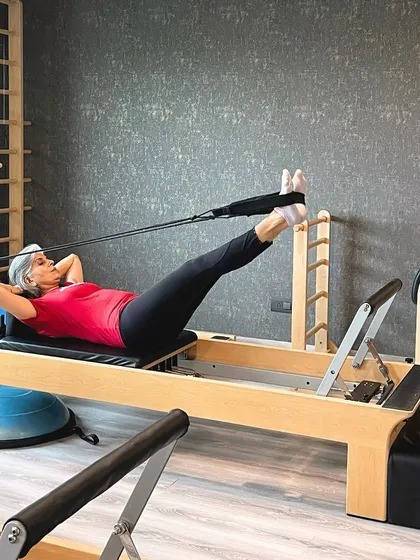 Proving that strength and flexibility are timeless. This client works on her core stability and leg strength in a private Reformer session.