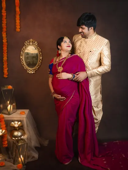 A loving gaze shared between the couple. This photo captures their deep connection amidst a beautifully decorated traditional studio setup.
