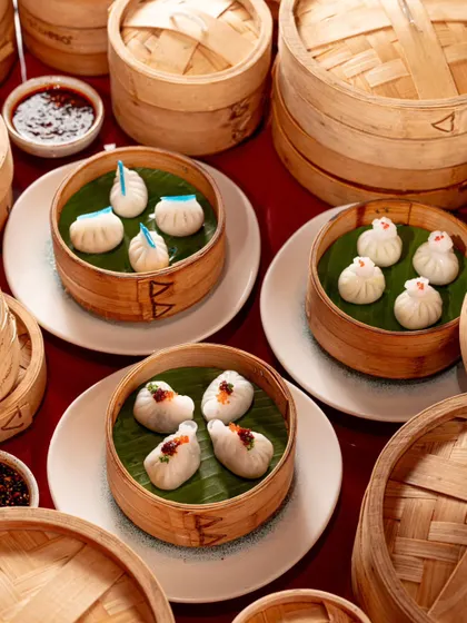 A collection of different dim sum varieties in bamboo steamers. This shot is perfect for showcasing a signature category on a restaurant's menu.
