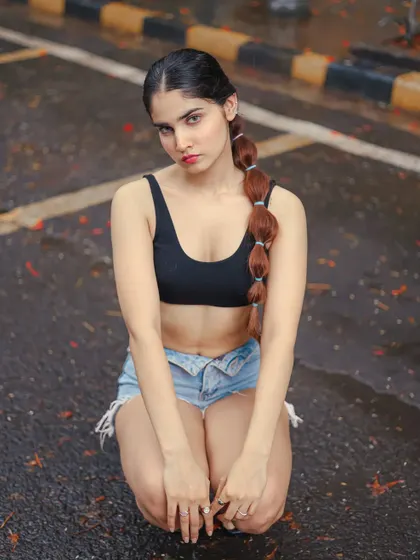 A kneeling pose from the street fitness shoot, offering a different perspective and highlighting the model's physique.