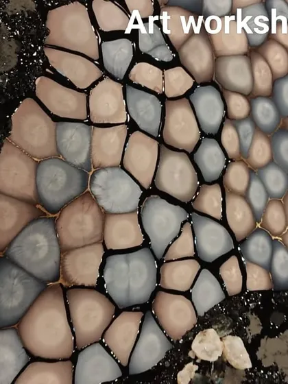A finished pebble resin art piece. The combination of different coloured pebbles and textures creates a stunning and realistic effect.