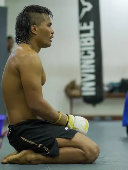 A moment of rest and reflection for a fighter between grappling rounds. The grind is constant, but so is the growth.