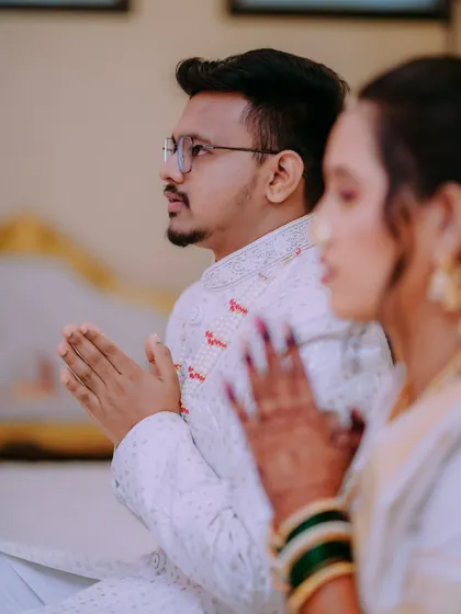 A side profile of the couple in prayer during their wedding ceremony, a moment of shared faith and devotion.