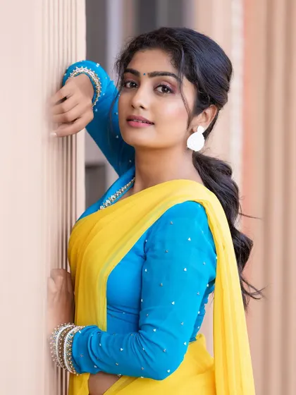 A close-up of the blue full-sleeve blouse. The scattered pearl work and delicate border on the neckline add just enough detail to this simple and elegant design.