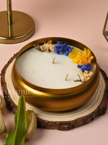 Here is the floral luxury Urli candle displayed on a natural wood slice, highlighting its rustic charm. It's a perfect piece for creating a serene, nature-inspired atmosphere.