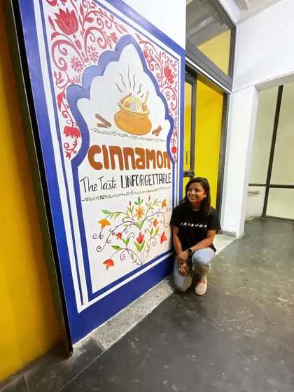 A proud moment with the completed mural. It’s always fulfilling to create art that becomes part of a business's identity.