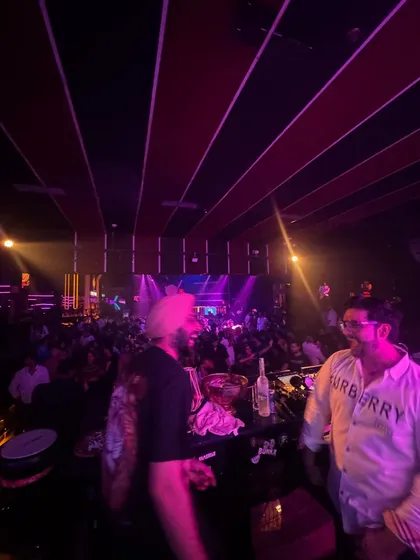 A candid moment with the DJ in a packed club. The energy and collaboration between us is what makes the night special.
