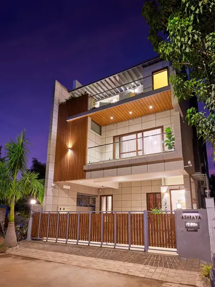 A duplicate image of the Odion Woods villa at dusk, showing the facade lighting.