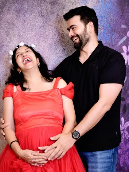 Pure, unscripted joy. This photo captures a moment of spontaneous laughter, which is always one of the best parts of any maternity session.