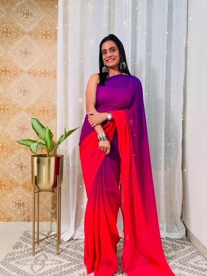 An ombre-dyed pre-stitched saree in shades of purple and red. The colors are beautiful and the effect is very eye-catching.