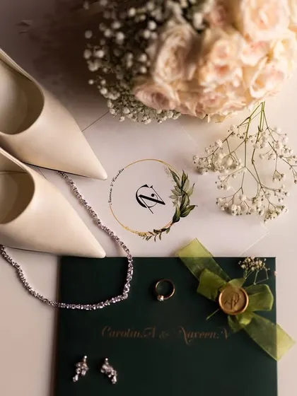 An elegant flat lay of the bride's accessories, including her shoes, jewelry, and the wedding invitation, telling the story of her day.