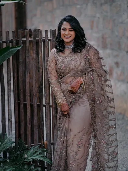 A full-length view of Ashwitha's stunning reception saree. The makeup was kept neutral and elegant to complement the intricate embroidery of her outfit.