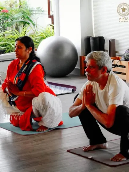 In our senior classes, we focus on foundational poses like Malasana (Garland Squat) to improve hip mobility and strength, with a focus on mindful movement.