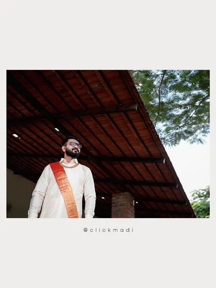 A portrait of the groom looking thoughtful and happy, captured at his outdoor wedding venue.
