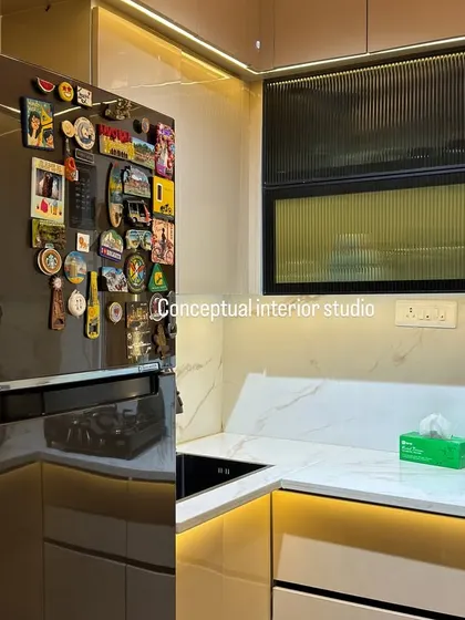 Another shot of the kitchen, highlighting the large, double-door refrigerator seamlessly integrated into the modular setup.