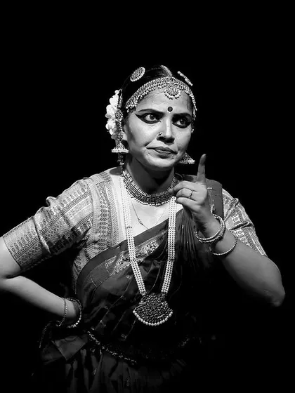 A striking black and white portrait from 'Rasayatra'. The high contrast and dramatic pose emphasize the power and intensity of the dancer's expression.