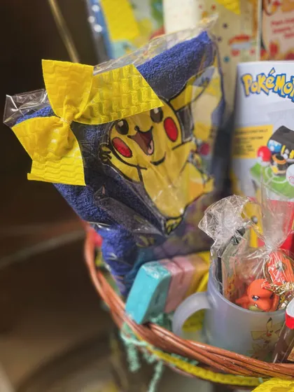A peek inside the Pokémon hamper, showing a Pikachu towel and other themed goodies that I sourced and curated to fit the birthday theme perfectly.