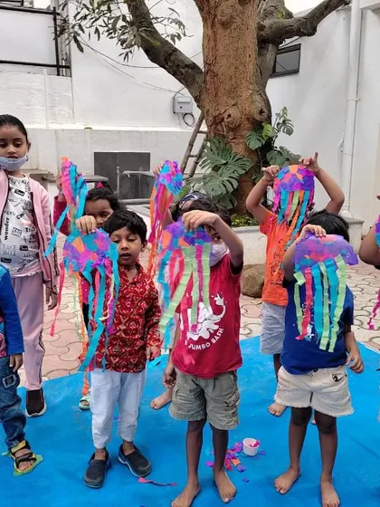 A group of proud kids showing off the colorful jellyfish suncatchers they made. Our "Under the Sea" workshop is a journey into ocean life through facts, stories, and art.
