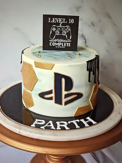 Level 16 complete! A PlayStation-themed cake for a gaming and football fan, featuring the iconic controller logo.