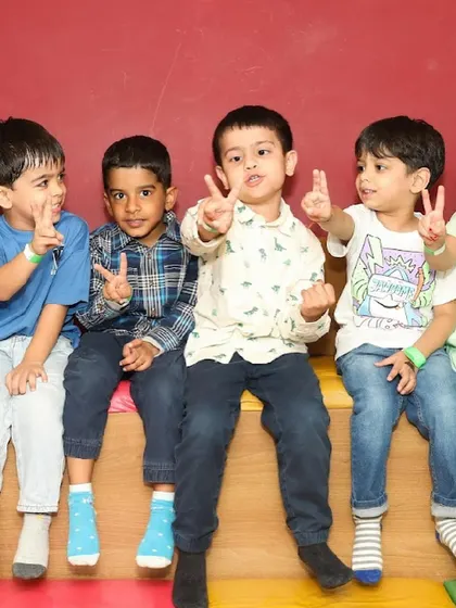 A group of boys flash peace signs for the camera.