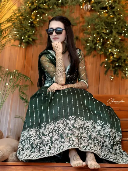 A modern bride with a bit of attitude. The sunglasses add a cool, contemporary twist to the traditional lehenga and mehndi.