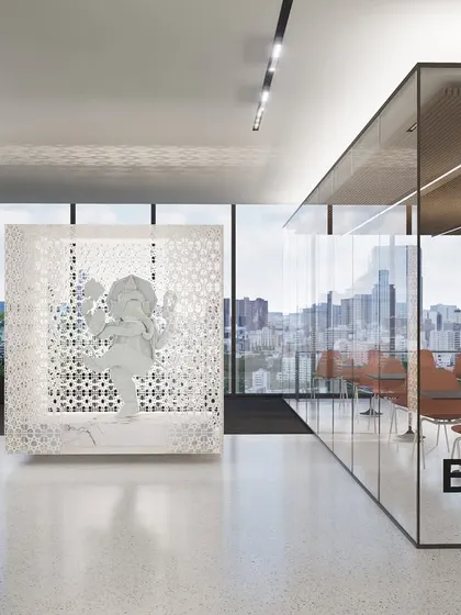 A 'Break' room at the Vian Office, enclosed in glass to maintain visual openness while providing a dedicated space for relaxation. The inclusion of a traditional Ganesha sculpture within a modern perforated screen shows our approach to integrating cultural elements in a contemporary context.