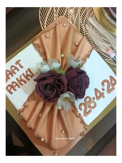 A closer look at the beautiful fondant draping on this "Baat Pakki" cake, accented with deep red roses and pearls.