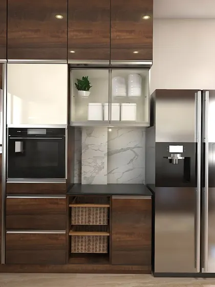 This view highlights the tall unit with a built-in oven and integrated refrigerator, showcasing our expertise in creating seamless and functional kitchen appliance solutions.