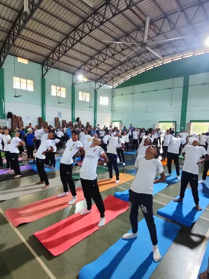 Students practicing back-bending asanas during a large-scale yoga session in Goa for International Yoga Day.