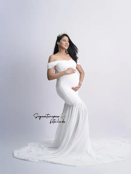 An angelic portrait in a simple white mermaid gown, with a crown adding a touch of royalty.