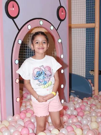 A young guest enjoying a quiet moment in our expansive ball pit.
