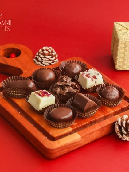 Our Box of 9 Assorted Chocolates makes for an elegant gift. Each box contains a variety of our handcrafted chocolates, including truffles, nut clusters, and filled chocolates.