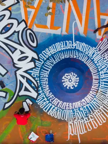 An aerial drone shot of a massive floor mural I collaborated on at the Carter Road skatepark in Bandra. My 'Mooz' tag is the centerpiece of this section.