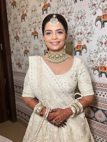 A smiling portrait of the bride. Her makeup is fresh and light, letting her natural radiance shine through.