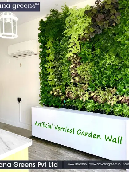 An artificial vertical garden wall installed in a clean, modern interior. Placed in a sleek white planter base, it acts as a freestanding natural divider, adding life to the space without any structural changes.