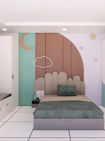 The sleeping area of our kids' bedroom design. It features a custom headboard and wall art with a dreamy cloud and moon theme, using a soft, pastel color palette.