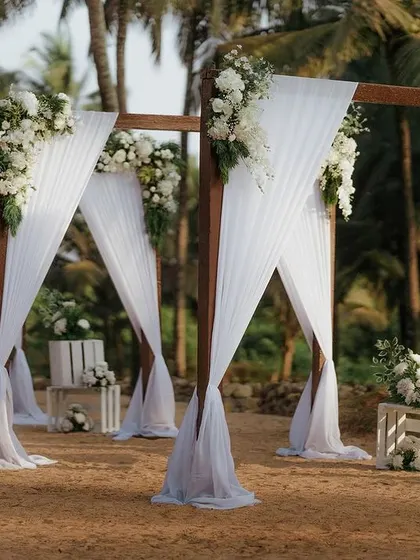 Another view of the beautiful white-draped aisle on the beach, creating a serene and picturesque path to the mandap.