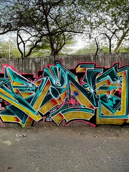 A sharp, aggressive wildstyle in green and gold. The arrow elements give the piece a sense of direction and movement.